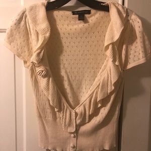 Cream short sleeve cardigan with flower detail.